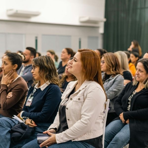 Group of educators attentively participating in a professional development workshop, representing the collaborative and focused training environment of the MockX® writing assessment program.